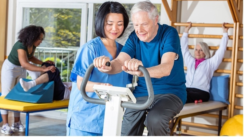 Older Person Exercising With Nurse